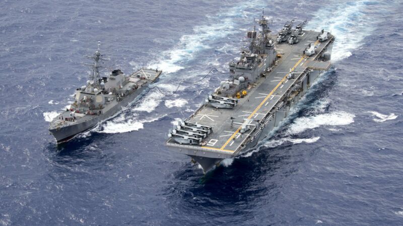 160915-N-WF272-390 PHILIPPINE SEA (Sept. 15, 2016) The Arleigh Burke-class guided-missile destroyer USS Curtis Wilber (DDG 54) steams alongside amphibious assault ship USS Bonhomme Richard (LHD 6) during a fueling at sea (FAS). Bonhomme Richard, flagship of the Bonhomme Richard Expeditionary Strike Group, is operating in the Philippine Sea in support of security and stability in the Indo-Asia Pacific region. (U.S. Navy photo by Mass Communication Specialist 2nd Class Diana Quinlan/Released)