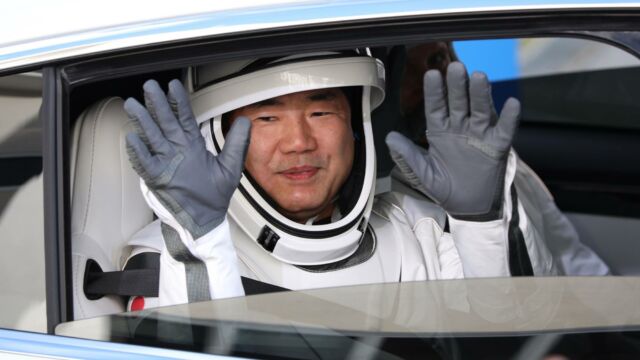 Crew-1 mission astronaut Soichi Noguch waves during the crew walkout at the Neil A. Armstrong Operations and Checkout Building en route to launch complex 39A at the Kennedy Space Center in Florida on November 15, 2020. - NASAs SpaceX Crew-1 mission is the first crew rotation mission of the SpaceX Crew Dragon spacecraft and Falcon 9 rocket to the International Space Station as part of the agencys Commercial Crew Program. NASA astronauts Mike Hopkins, Victor Glover, and Shannon Walker, and astronaut Soichi Noguchi of the Japan Aerospace Exploration Agency (JAXA) are scheduled to launch at 7:27 p.m. EST on November 15, from Launch Complex 39A at the Kennedy Space Center. (Photo by Gregg Newton / Gregg Newton / AFP)
